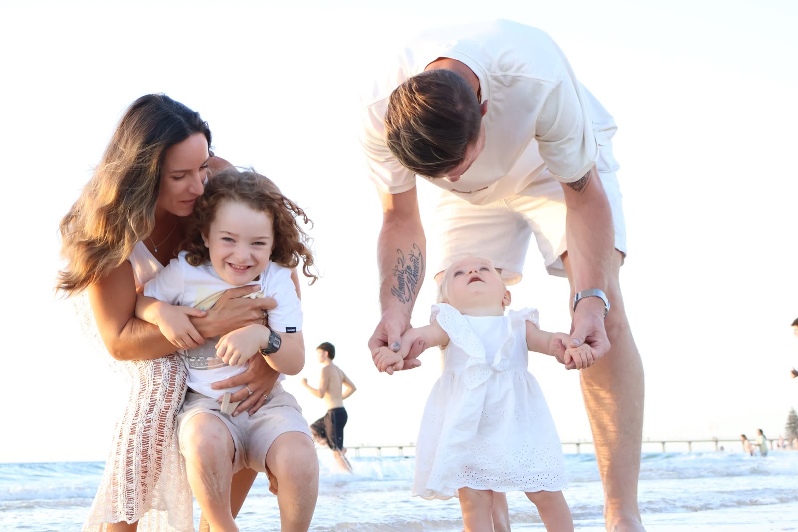Family playing in the shallows at an Adelaide beach